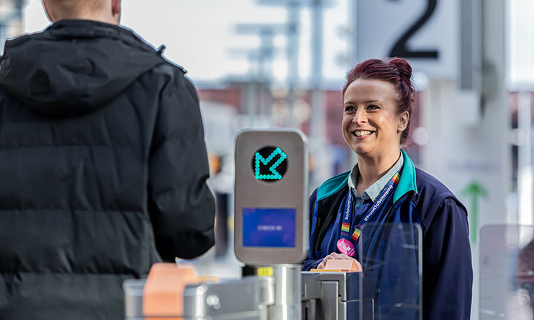 A northern employee engaging with a passenger