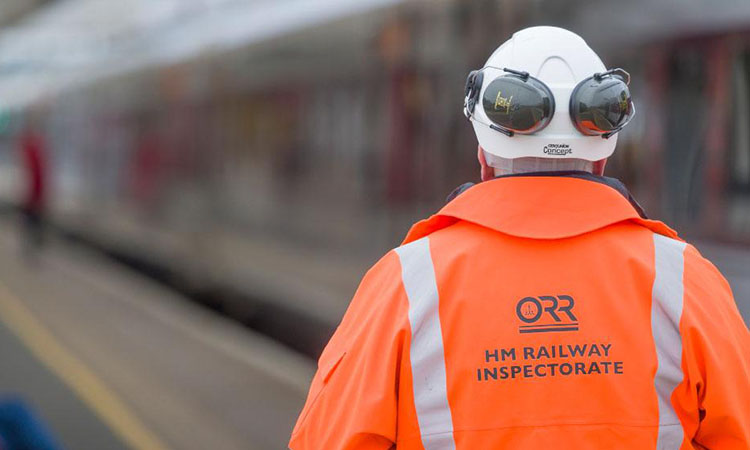 ORR inspector at work looking over a British railway