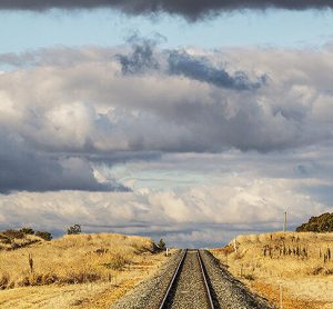 Vast landscape with rail tracks running through the foreground