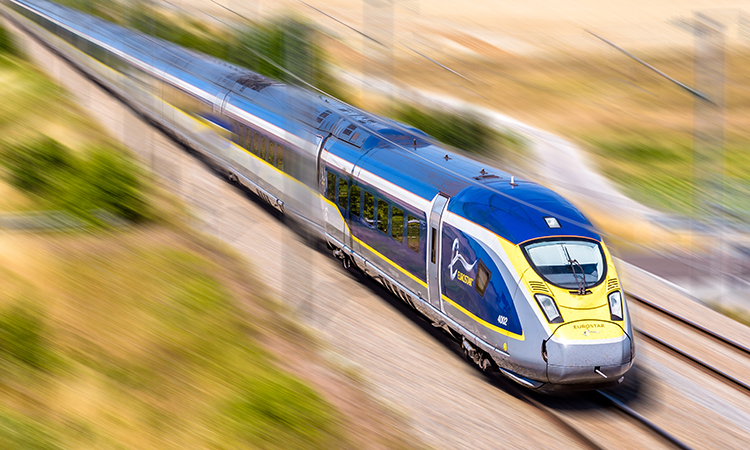 A Eurostar train at high speed in the French countryside.