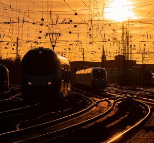 火车在温暖的黄昏抵达多特蒙德车站，弯弯曲曲的铁路干线在阳光下闪闪发光。